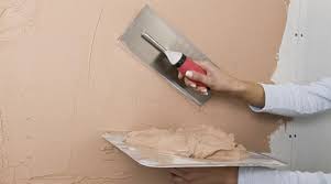 A interior wall being plastered