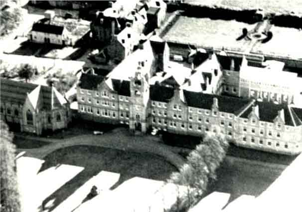 College from the air showing part of the heart shaped lawn, the statue, and part of the chapel to the left