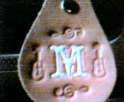 M with musical notation