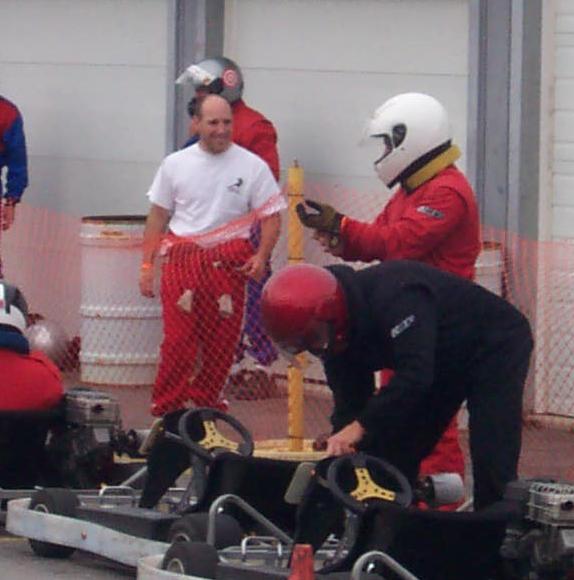 Michael (white helment) getting ready to get in his kart to race