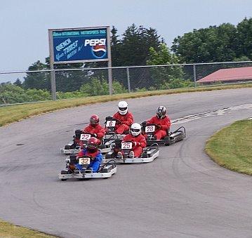 The karts race through turn 4