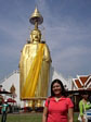 With the standing Buddha at the Wat Intharawihan