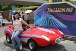 With a shiny red sports car!