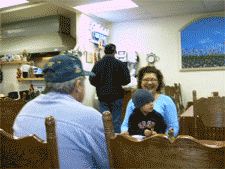 Another Grandma, pa, and grandson wait while someone gets take-out after work.
