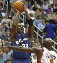 MJ takes a shot over Atlanta Hawks guard Dion Glover during the first half in Atlanta. (AP) 