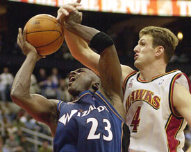 MJ is fouled by Atlanta Hawks' Chris Crawford in Atlanta. Jordan scored 31 points as the Wizards defeated the Hawks 98-88. (AP) 