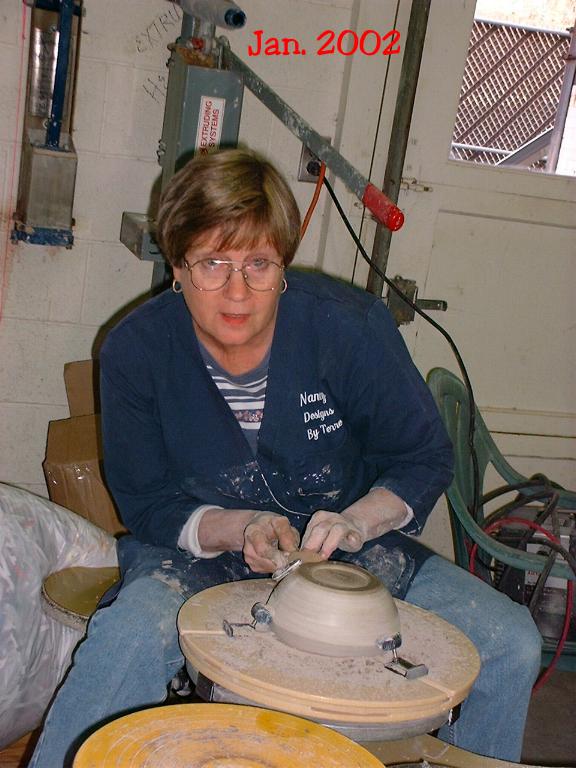 Nancy at the wheel trimming a pot