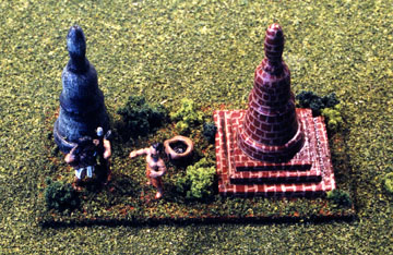 Monk and Asian soldier converse near SE Asian stupas