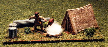 A haunch of meat roasts over a camp set amidst classical ruins