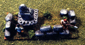 A Stone Buddha presides over a ruined temple complex
