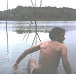 man entering a rath bog for a quick swim 