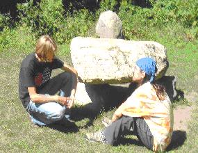  Matt and Sean sitting at the Stone Circle's three ton central trilithion altar surrounded by a dozen man-size boulders, a quiet and gentle place to relax.