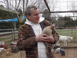 Wayne holding an unhappy guinea