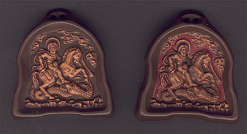 The miniature ceramic relief`s sculpture `Saint George and the Dragon`.