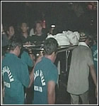 A body is removed from the wreckage