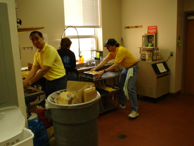 Winston Mina, Janie Farfan, and Treasurer Ed Young help clean up