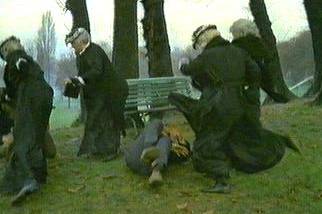 Old ladies kicking a down criminal