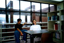 in the library... researching.... (or looking at girls??)