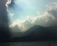 view from a boat - the sun shines through the clouds