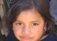 note the pierced ears kept open by thread
