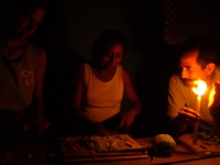 chopping veggies by candlelight in one of the villages that has no electricity