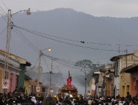 the procession winds its way through the streets of Antigua