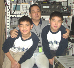This Tom Watanabe JA1KJK, long time member of DX1HB. A multi awarded dxer, he sits with his two sons in his radio room!