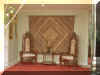King chairs in front of an Indian tapestry