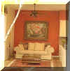 Kitchen - After:  Brick red wall paint and an antique picture on the wall give a more cozy and relaxed feel.