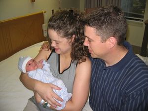 Pic, Mom and Dad holding son.
