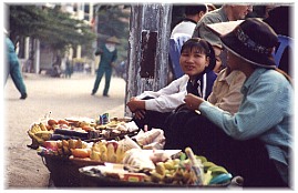 selling fruits very early on Cat Ba Island at Halong Bay - main target customers are foreigners
