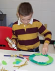 Child making advent wreath craft