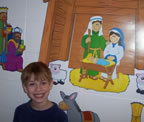 Smiling child by nativity scene
