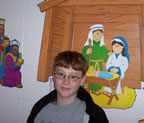 Happy child near nativity scene