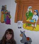 Girl near nativity scene
