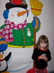 Little girl near snowman
