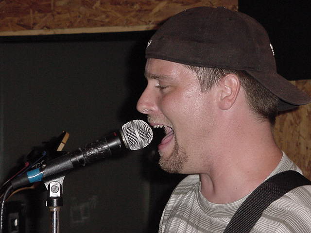 Is he singing or eating that mike?