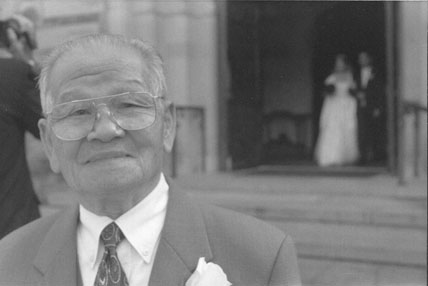 Grandpa with Bride & Groom in background