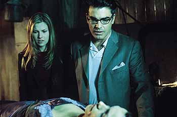 Ali Larter and Peter Gallager look at the not-quite dead Famke Janssen