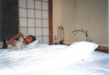 A friend of mine blowing her flute on the bed