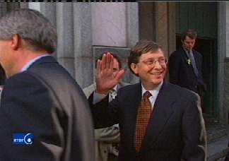Waving gaily, the boy billionaire smiles at the friendly Belgian people...