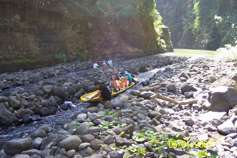 Madz, Del and Grace aboard the native canoe in the rapids.