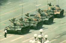 Man in front of tanks