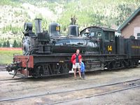 Dad & Cole in front of one of the old engines.