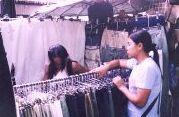 A daring nic get changed at a makeshift fitting room of roadside stall, under the watchful eyes of the stall owner!