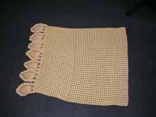 Crochet yellow blanket with pineapple edging
