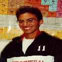 Me at barely 16.  Note the Periodic Table in the background (do I see Cadium [Cd] in the corner?) and the glasses.