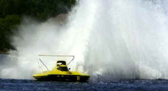 The "Llumar Window Films" hydroplane digs into the corner.