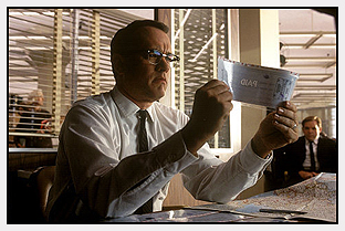Carl Hanratty (Tom Hanks) examines cheque