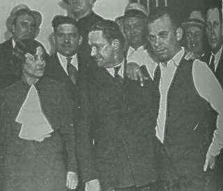 The infamous picture of Dillinger leaning on the man who was to prosecute him as he enters Crown Point jail as a celebrity.